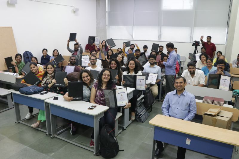 The whole cohort holding certificates in the classroom