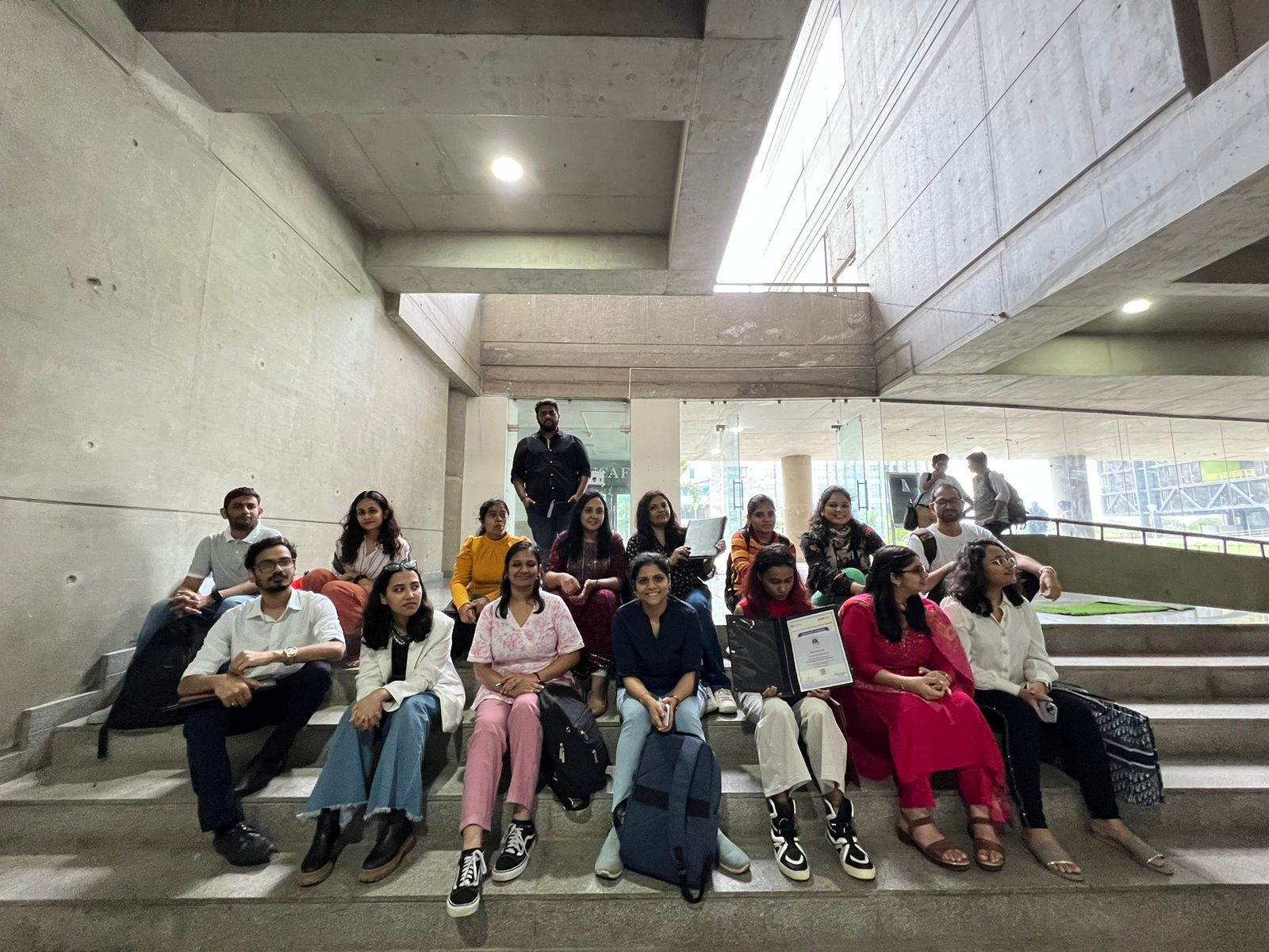 Sitting on the concrete stairs of the design block